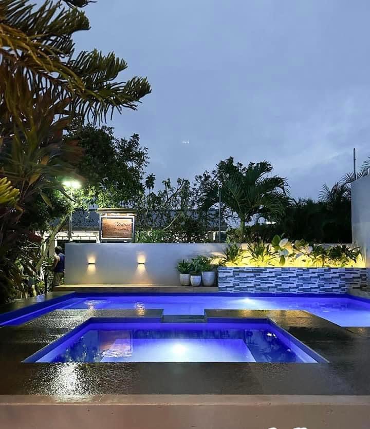 Villa 1 pool with jacuzzi lights at night